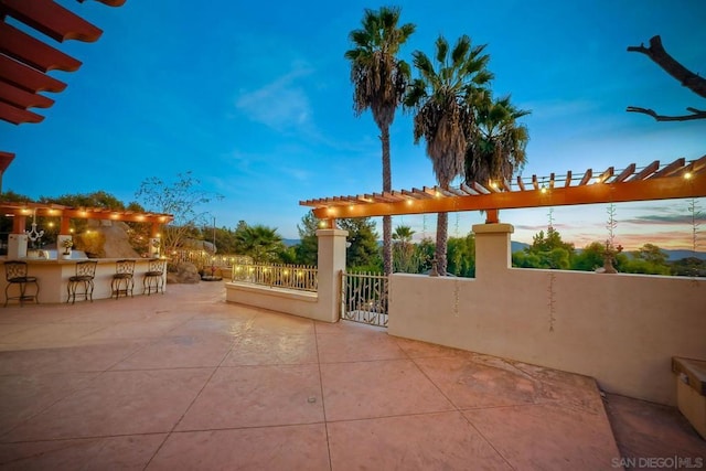 patio terrace at dusk with an outdoor bar