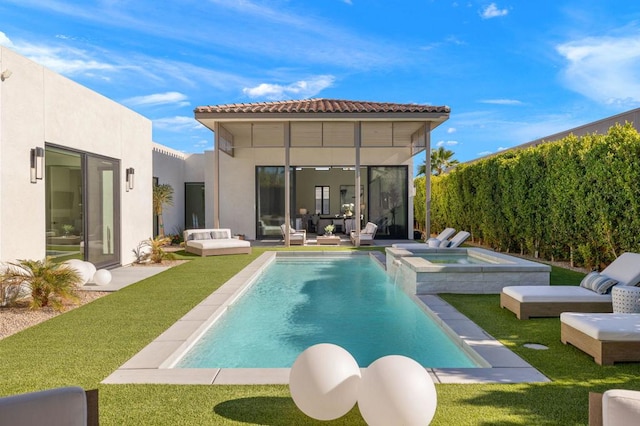 back of property featuring a swimming pool with hot tub and an outdoor living space