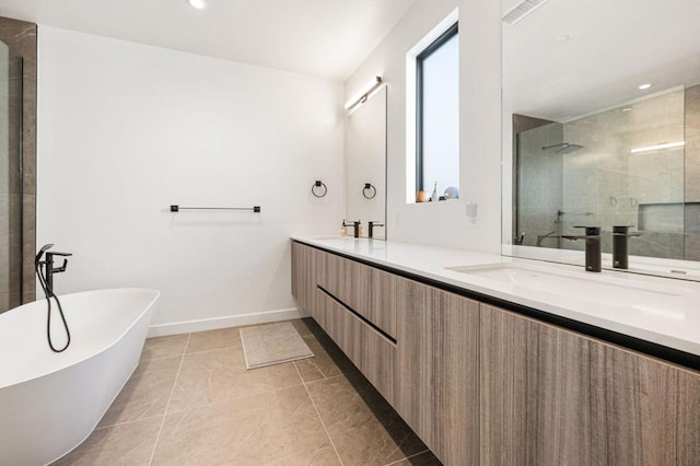 bathroom featuring tile patterned floors, vanity, and shower with separate bathtub