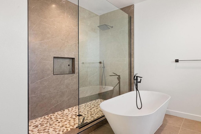 bathroom featuring shower with separate bathtub and tile patterned flooring