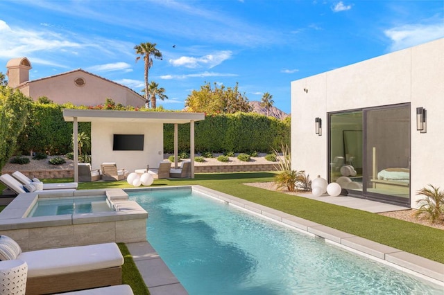 view of pool with an outdoor hangout area, an in ground hot tub, and a yard