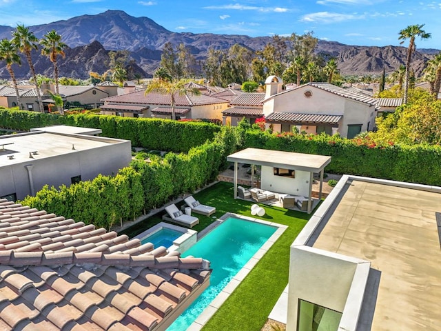 view of swimming pool with an outdoor hangout area, a patio area, and a mountain view