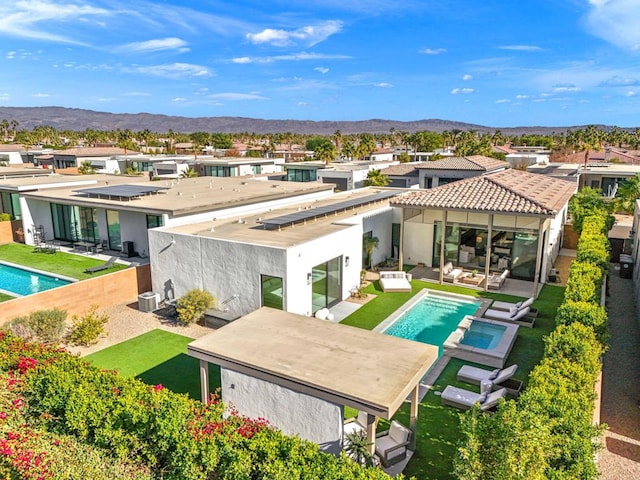 back of property featuring central air condition unit, an outdoor living space, a patio area, and a mountain view