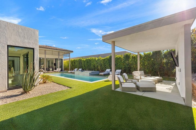 view of yard with a patio area and a pool with hot tub