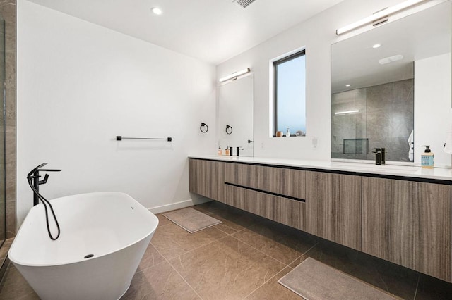 bathroom with tile patterned floors, vanity, and plus walk in shower