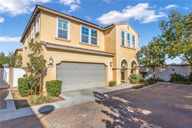 mediterranean / spanish-style home with a garage