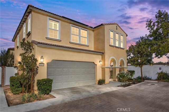 mediterranean / spanish house featuring a garage