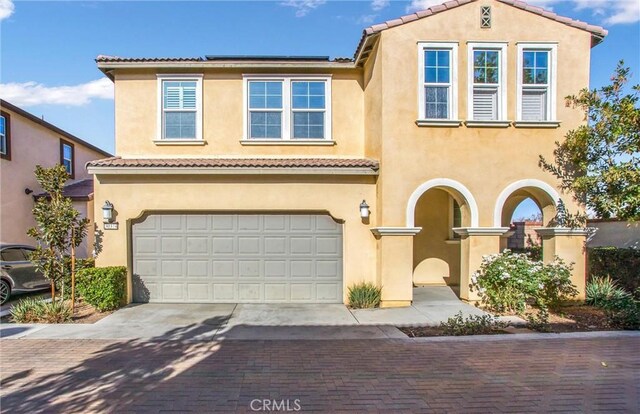 mediterranean / spanish house with a garage