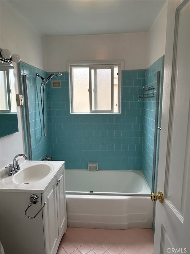 bathroom featuring vanity, tiled shower / bath combo, and tile patterned floors