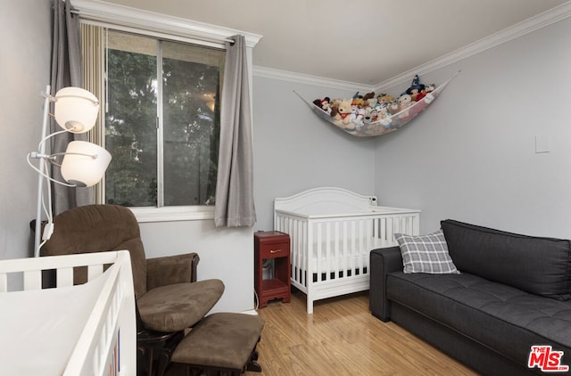 bedroom with crown molding and light wood-type flooring