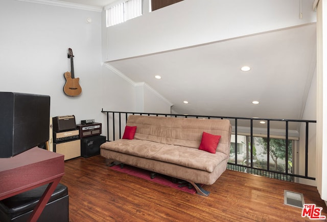 living room featuring dark hardwood / wood-style flooring and ornamental molding