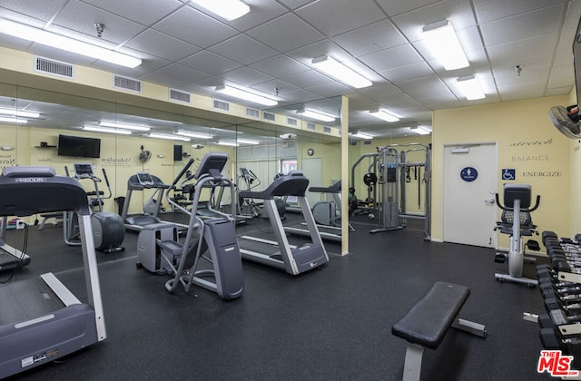 exercise room with a paneled ceiling