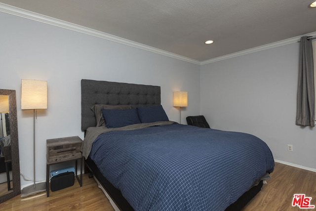 bedroom featuring crown molding and hardwood / wood-style floors