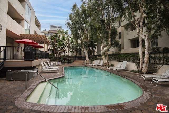 view of pool with a pergola and a patio