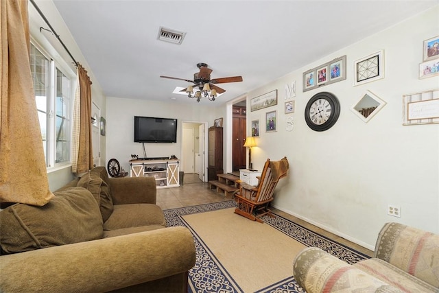 tiled living room with ceiling fan