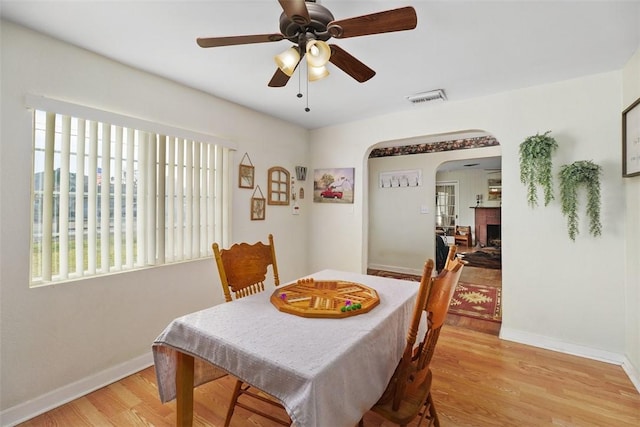 dining space featuring ceiling fan and light wood-type flooring