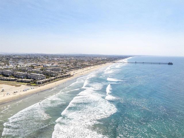 birds eye view of property with a beach view and a water view