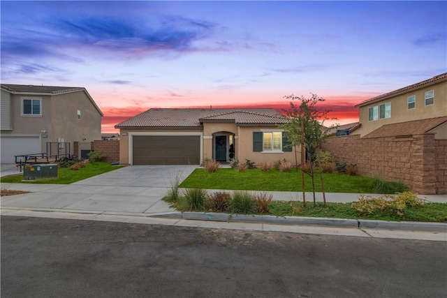 view of front of house featuring a yard and a garage