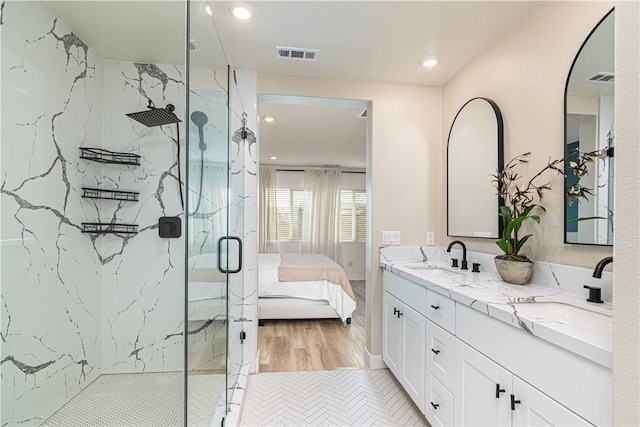 bathroom with vanity and a shower with shower door