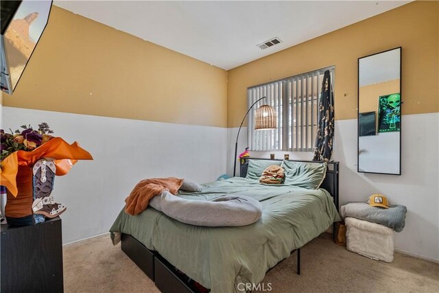 bedroom featuring light carpet