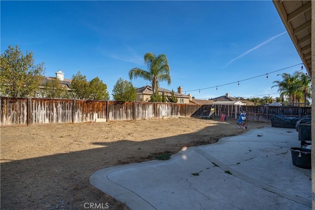 view of yard with a patio area and a playground