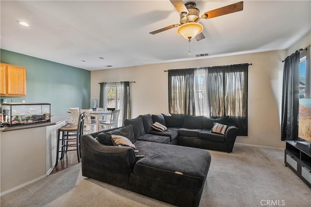 carpeted living room featuring ceiling fan