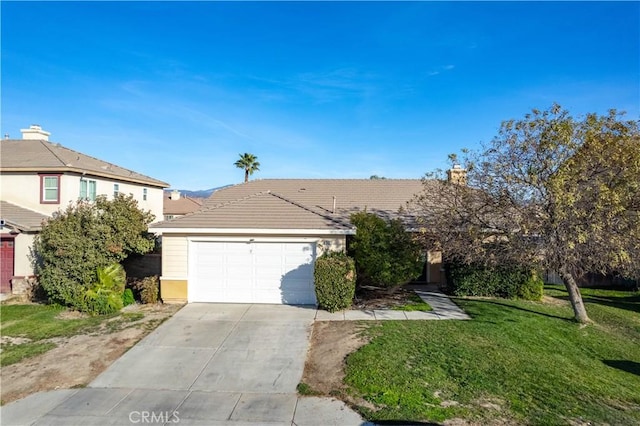 view of front of property with a tiled roof, driveway, an attached garage, and a front lawn