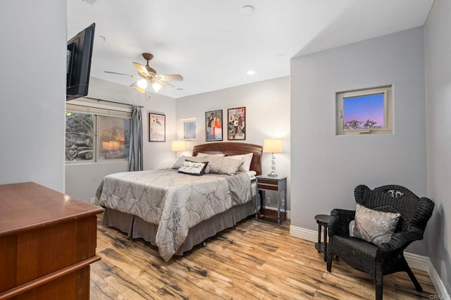 bedroom with ceiling fan and light wood-type flooring