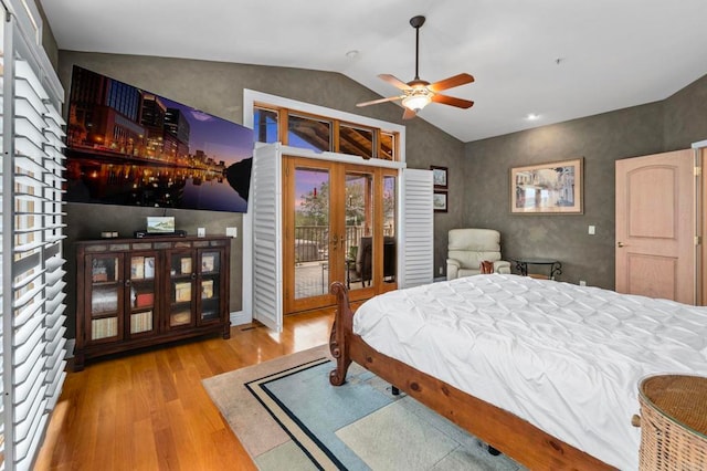 bedroom featuring ceiling fan, vaulted ceiling, access to outside, light hardwood / wood-style flooring, and french doors