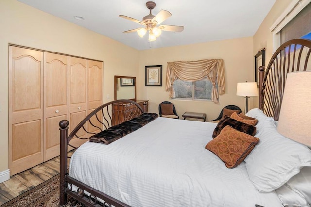 bedroom featuring ceiling fan, a closet, and wood-type flooring