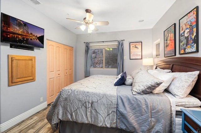 bedroom with ceiling fan, hardwood / wood-style floors, and a closet