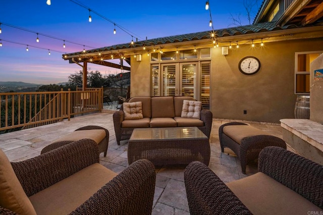 patio terrace at dusk with an outdoor living space