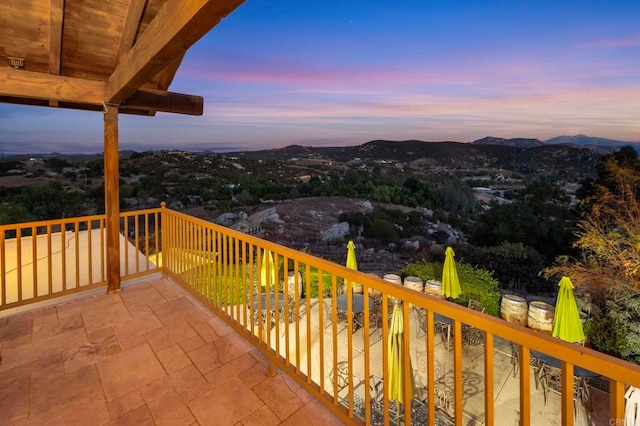 deck at dusk featuring a mountain view