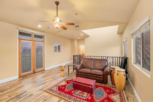 living room featuring ceiling fan, wood-type flooring, french doors, and lofted ceiling