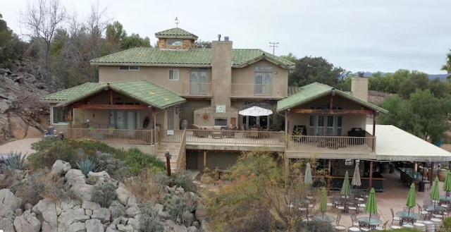 back of house with a patio area and a balcony