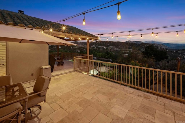 patio terrace at dusk with a mountain view