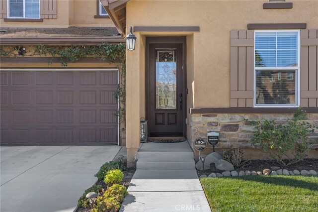 view of exterior entry with a garage