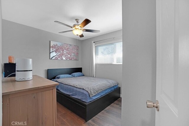 bedroom featuring dark wood-type flooring and ceiling fan