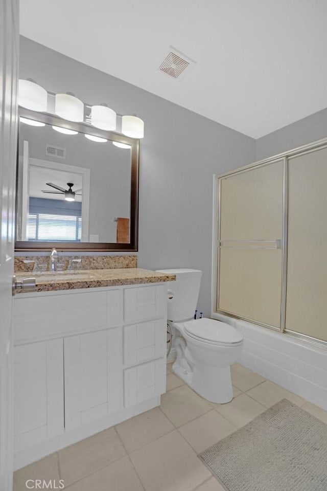 full bathroom with toilet, combined bath / shower with glass door, ceiling fan, tile patterned floors, and vanity