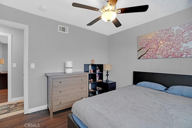 bedroom with ceiling fan and dark hardwood / wood-style floors