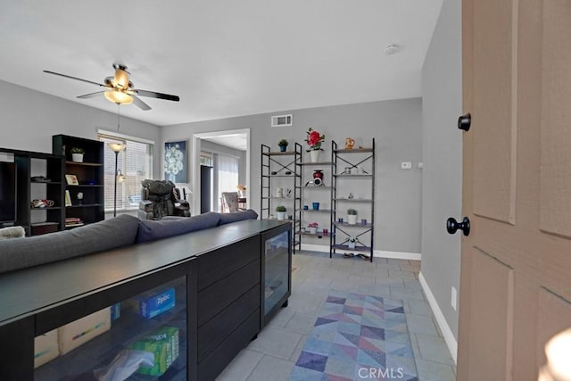 tiled living room featuring ceiling fan