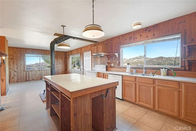 kitchen featuring a mountain view, wooden walls, sink, and white appliances