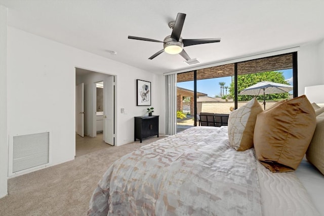 carpeted bedroom featuring ceiling fan, a wall of windows, and access to exterior