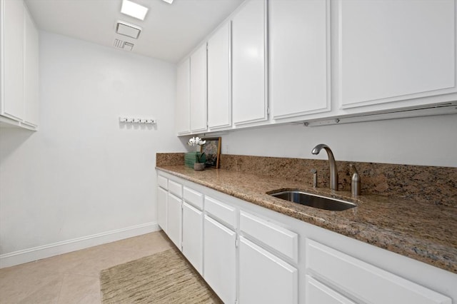 clothes washing area with light tile patterned floors and sink