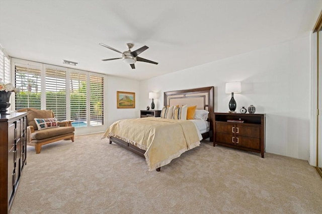 carpeted bedroom with ceiling fan and access to outside