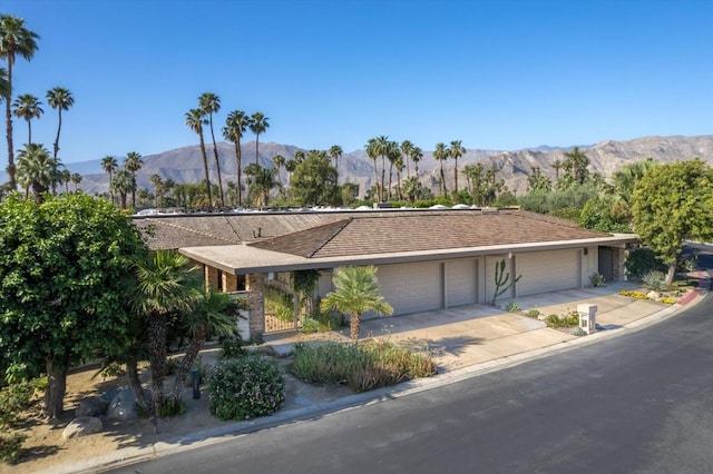 view of front of home featuring a mountain view and a garage