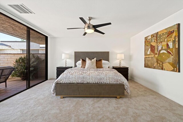 carpeted bedroom with ceiling fan and access to outside