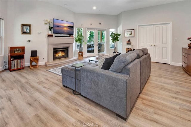 living room with french doors and light hardwood / wood-style flooring