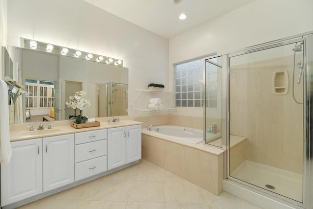 bathroom with tile patterned flooring, separate shower and tub, and vanity