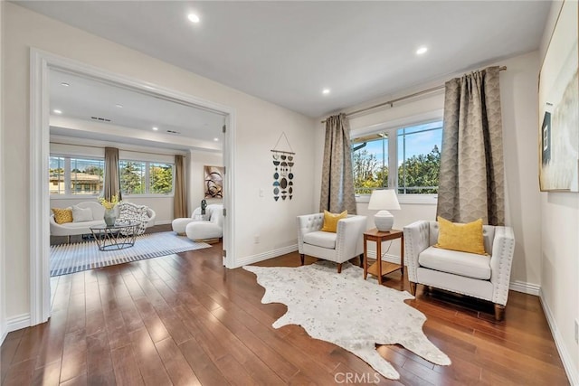 sitting room featuring dark hardwood / wood-style floors and a healthy amount of sunlight